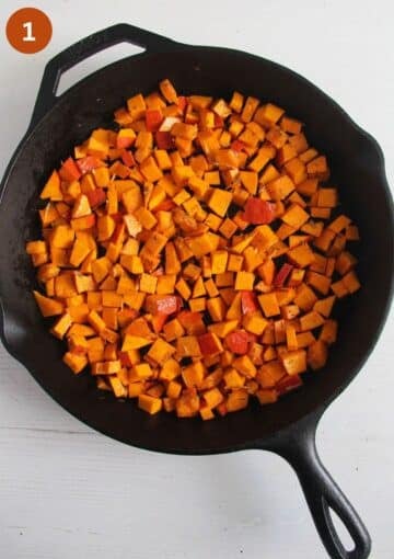 uncooked pumpkin pieces in a skillet for frittata.