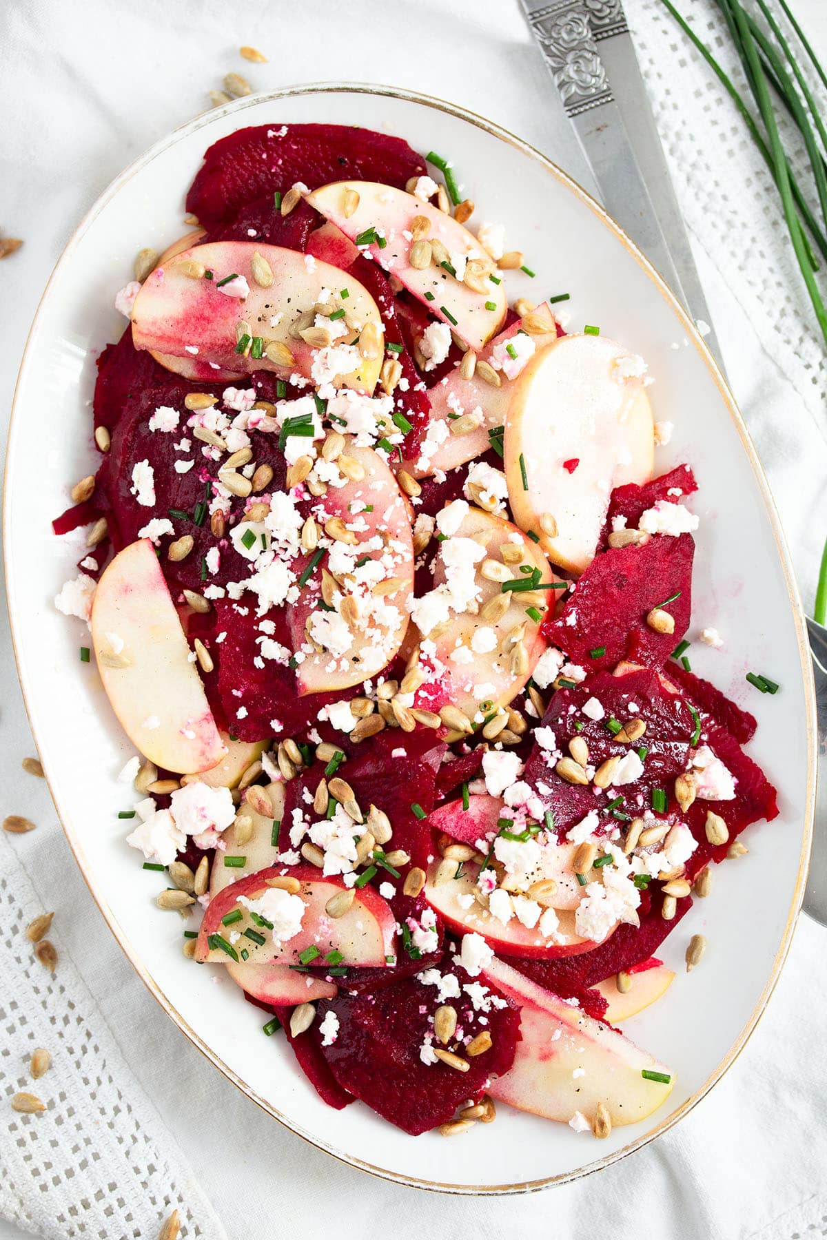 raw beetroot salad with feta on a large oval platter.