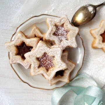 star-shaped german spitzbuben cookies on a small vintage plate.