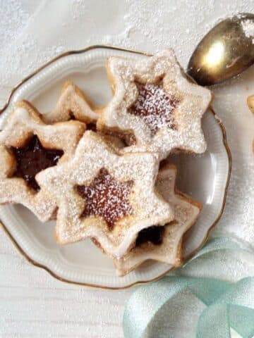 star-shaped german spitzbuben cookies on a small vintage plate.