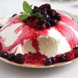 yogurt bomb dessert with berry sauce dripping.