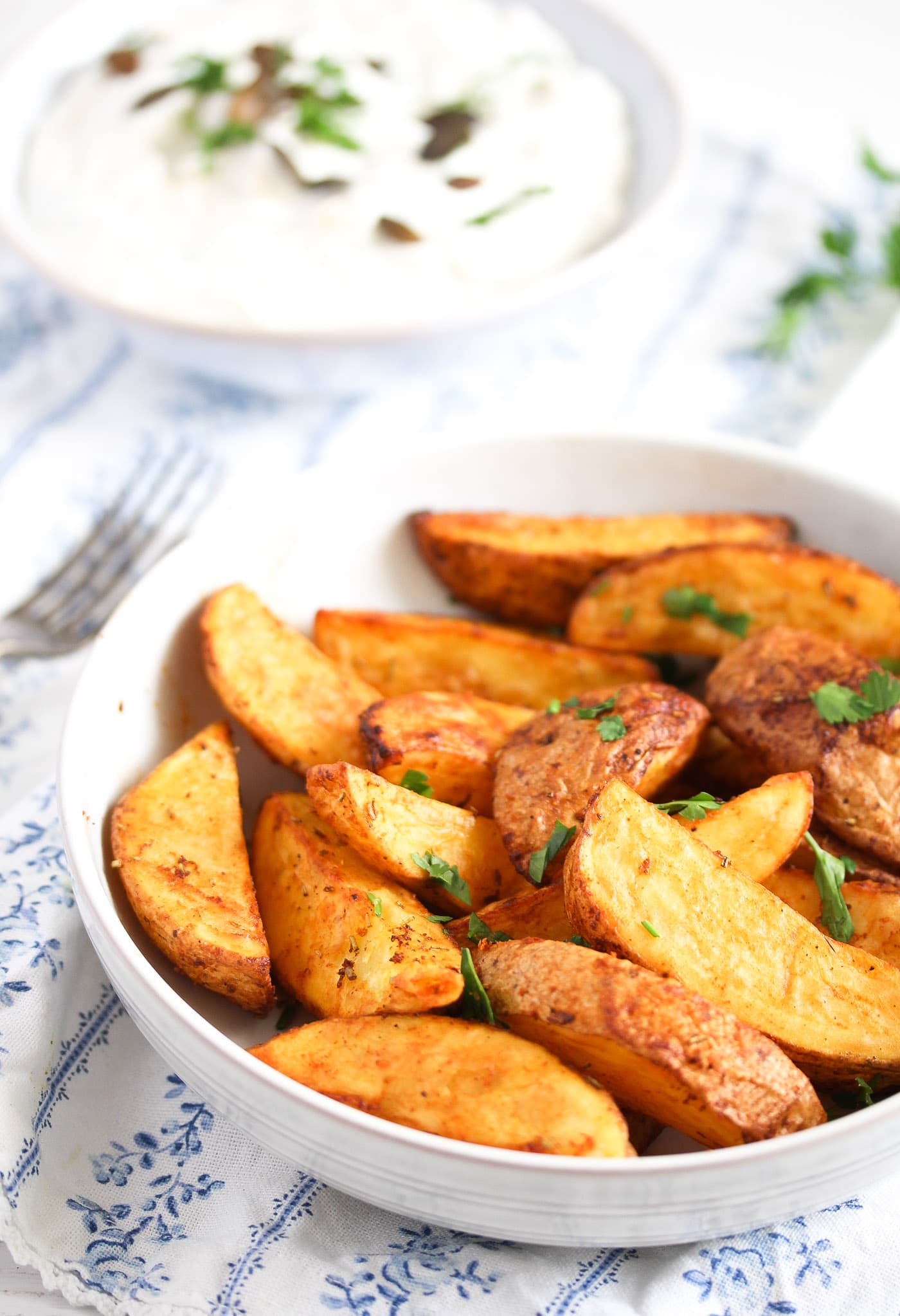 bowls with potatoes and sour cream dip in the back