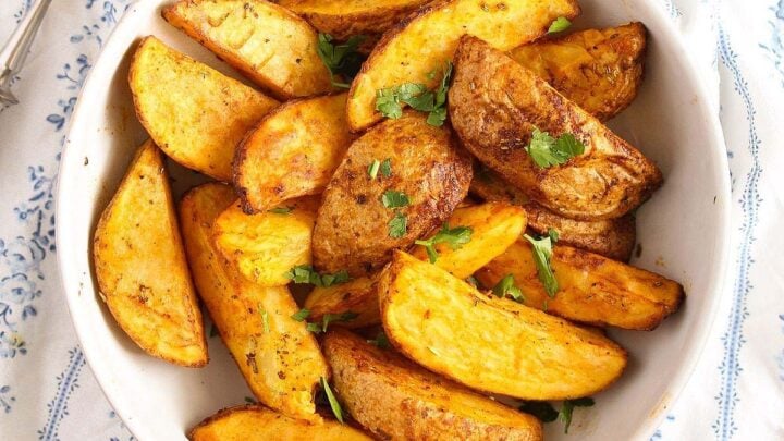 bowl of air fryer potato wedges and a fork.