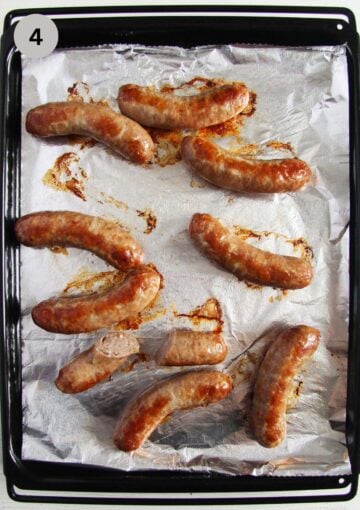 baked brats on a baking sheet lined with aluminum foil.