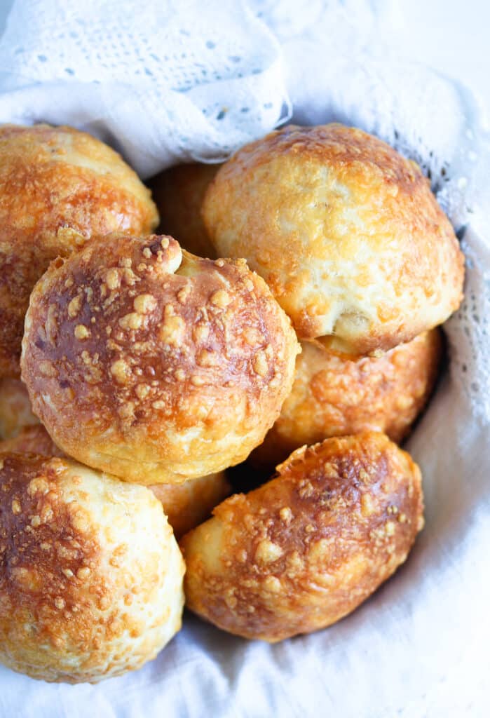 cheddar cheese buns in a basket