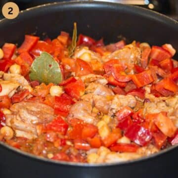 simmering chicken and pepper pieces in a large pot on the stovetop.