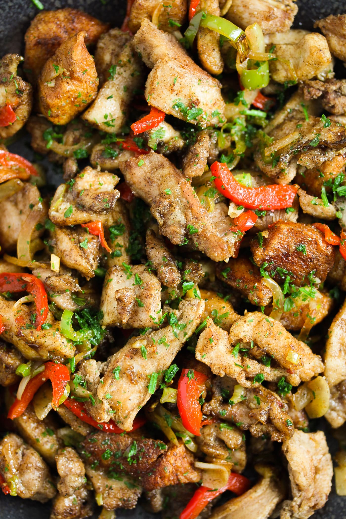 close up fried chicken pieces and peppers