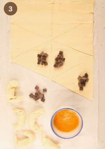 filling puff pastry triangles with chocolate chunks and a bowl of beaten egg.