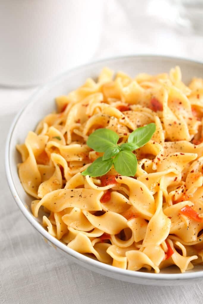 bowl with noodles topped with basil