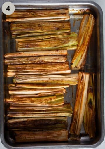 roasted pieces of leek in a roasting pan.