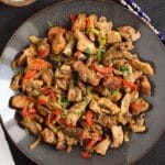 salt and pepper chicken on a brown plate overhead shot.