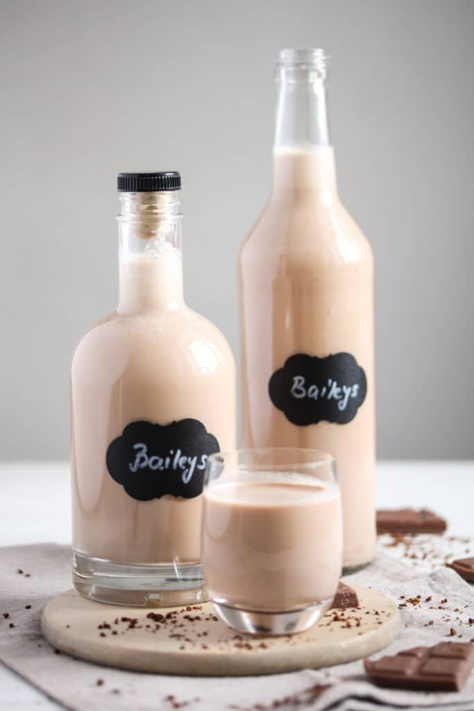 two bottles and a glass of thermomix baileys on a table
