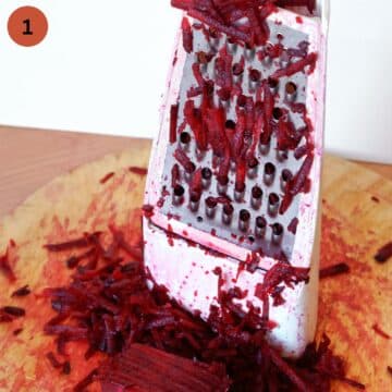 grating raw beets on a grater with large holes.
