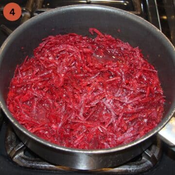 adding grated beetroot to a pan to cook a sauce for pasta.