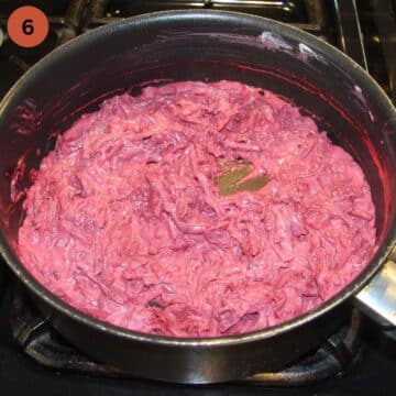 cooking beetroot pasta sauce with dairy in a deep pan.