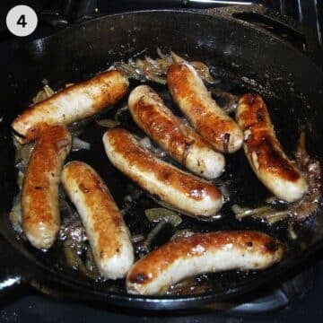 brats cooked on the stove top in a skillet with beer and onions.