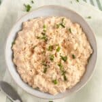 camembert dip with cream cheese and green onions in a small bowl.