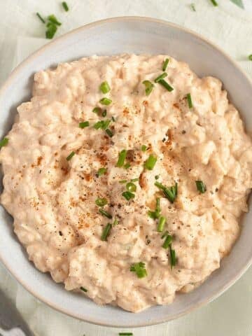 camembert dip with cream cheese and green onions in a small bowl.