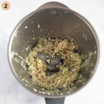 finely chopped green onions and camembert for making dip in a food processor.