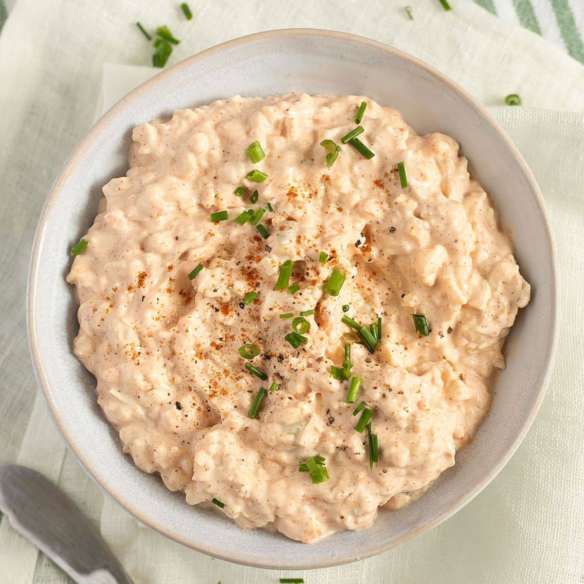 camembert dip with cream cheese and green onions in a small bowl.