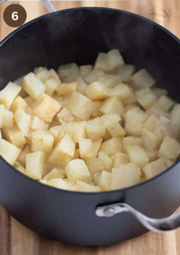cooked celery root pieces in a pot.
