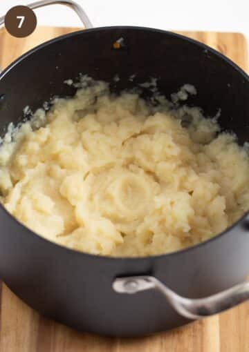 mashed celery root in a cooking pot.