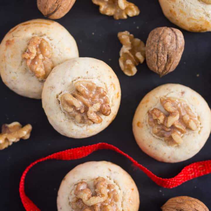 cookies, walnuts and a red ribbon on a black board