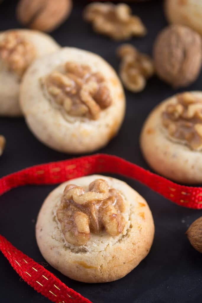 cookies with walnuts and a red ribbon in between