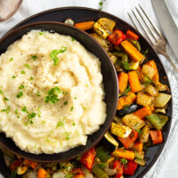 bowll of celery root mash served with roasted vegetables.
