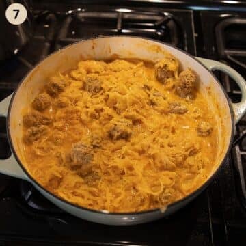 meatballs with sauerkrat in a pot after adding sour cream.
