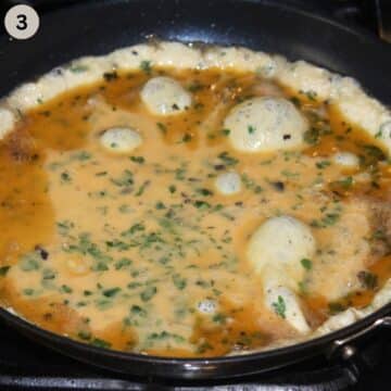 not quite cooked scrambled eggs in a large pan.