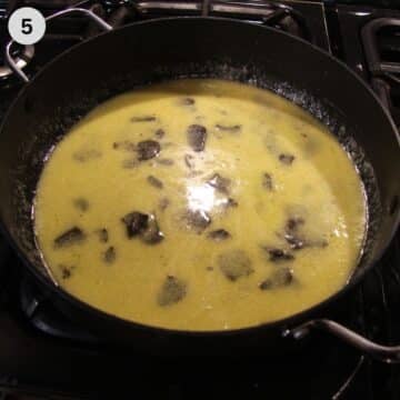 butter parmesan sauce with shaved black truffles in a pan.