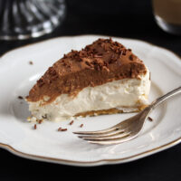 creamy slice of irish cream cheesecake on a vintage plate.