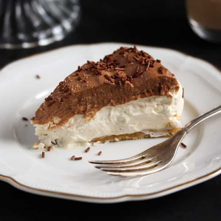 creamy slice of irish cream cheesecake on a vintage plate.