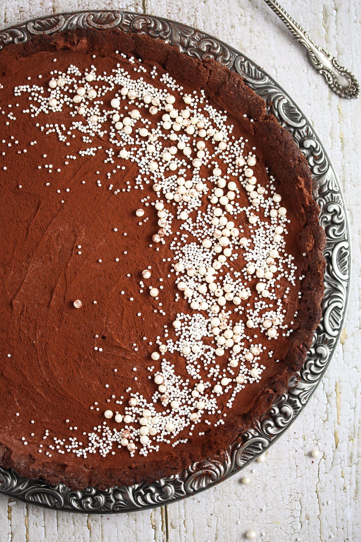 chocolate tart with bailey's sprinkled with sugar pearls.