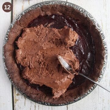 spreading ganache with a spoon in a chocolate tart shell.