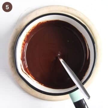 chocolate mixture stirred with a spoon in a saucepan.