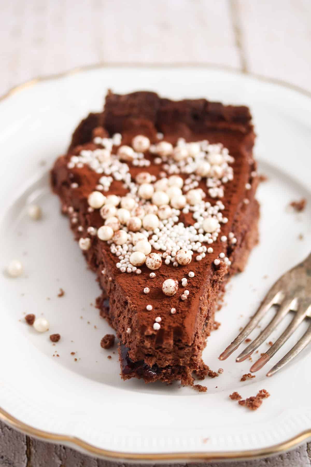 slice of bailey's chocolate tart on a vintage plate. 