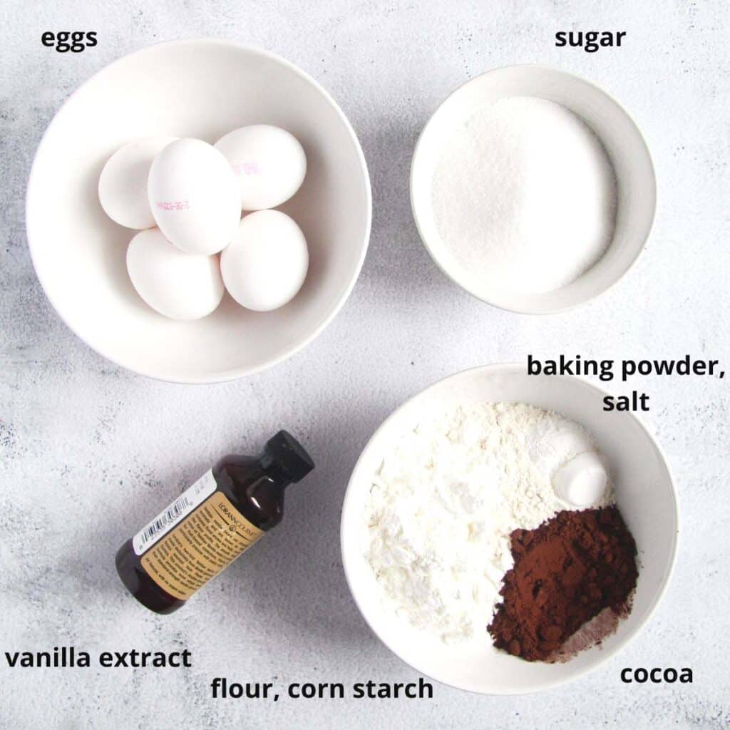 eggs, flour, vanilla, sugar in bowls on the table.
