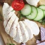 boiled frozen chicken breast with tomato and cucumber slices.