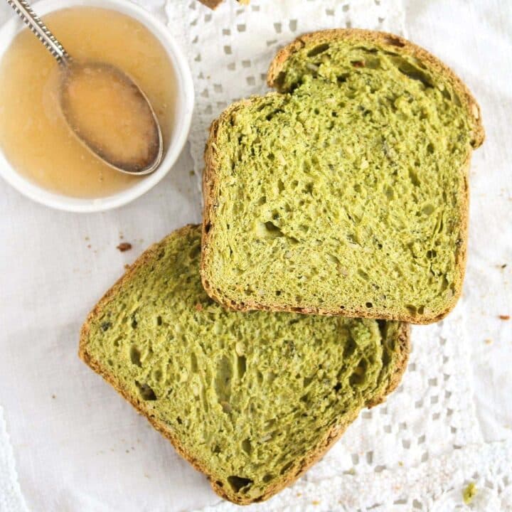 green spinach bread slices and a small bowl of jam.