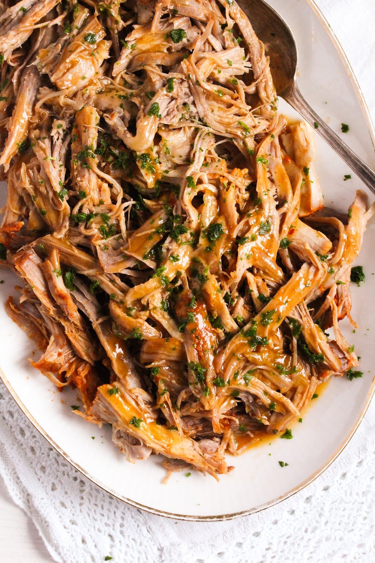 pulled pork cooked in a dutch oven and shredded on a plate.