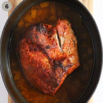 cooked pork shoulder in a dutch oven.
