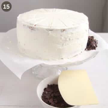 cake covered in cream and ready to be decorated with chocolate shavings.