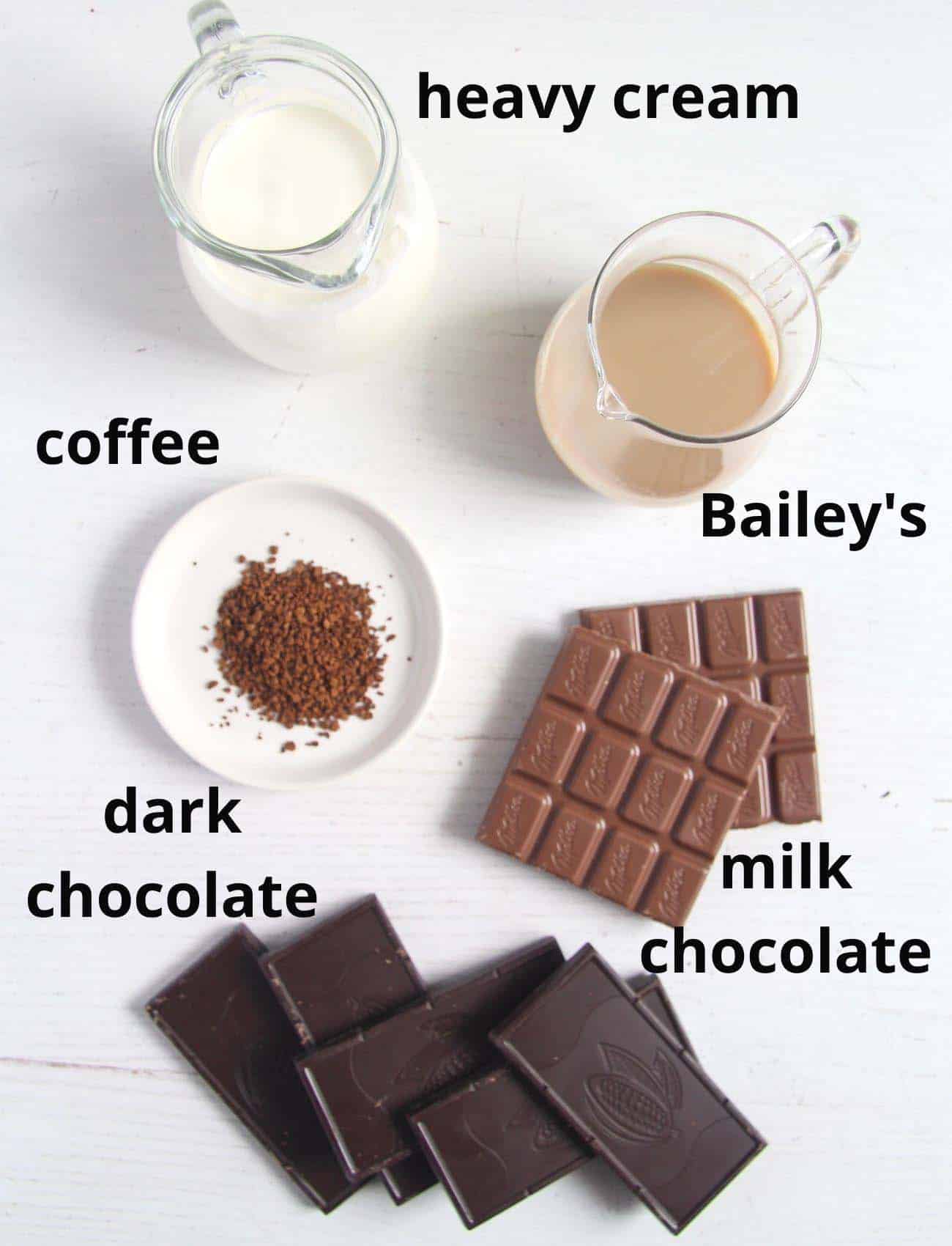 cream, bailey's, coffee, chocolate on a white table.