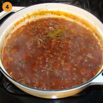 lamb ragu simmering in a large dutch oven.