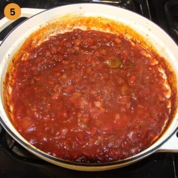 ragu sauce simmering in a dutch oven.