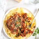 pinterest image with the title leftover lamb ragu with pasta.