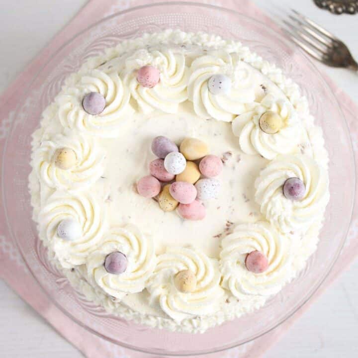 mini egg cheesecake on a pink cloth seen from above.
