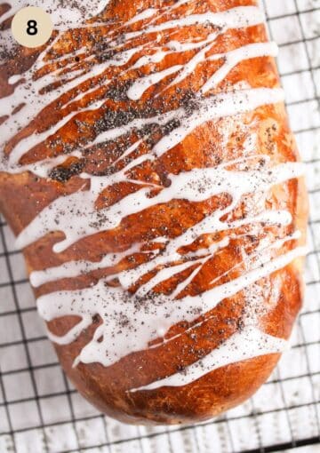 makowiec roll drizzled with powdered sugar glaze and poppy seeds.